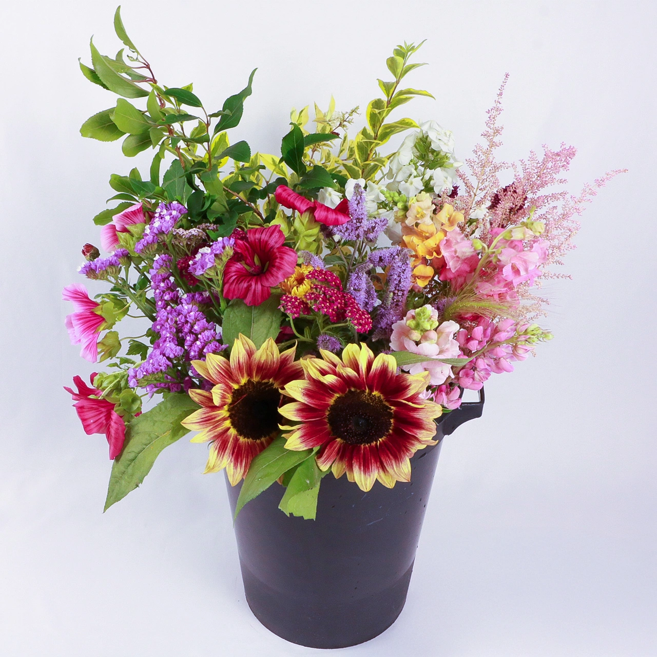 Marguerite Rose DIY flower bucket with fresh sustainably-grown Devon sunflowers, purple statice, pink cosmos, and mixed foliage