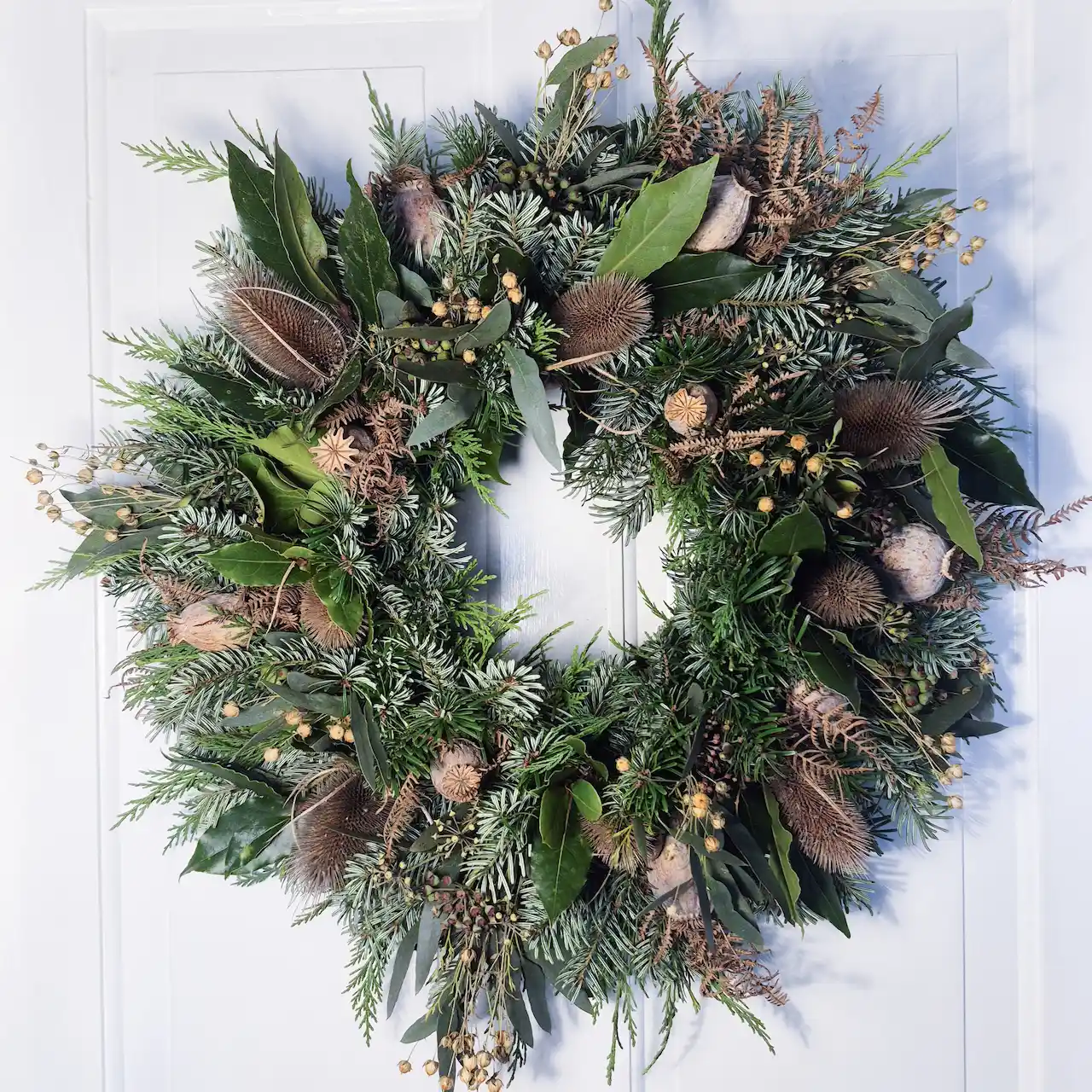 he Winter Gathering large moss Christmas wreath with poppy seed heads, teasels, banksia, ivy, pine and dried ferns handmade in Devon
