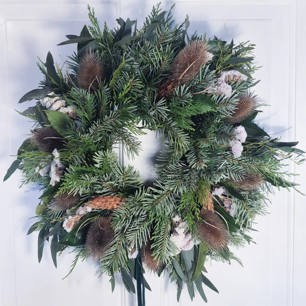 The Frosted Field medium moss Christmas wreath with dried teasels, white statice, pine, bay leaves and eucalyptus handmade in Devon